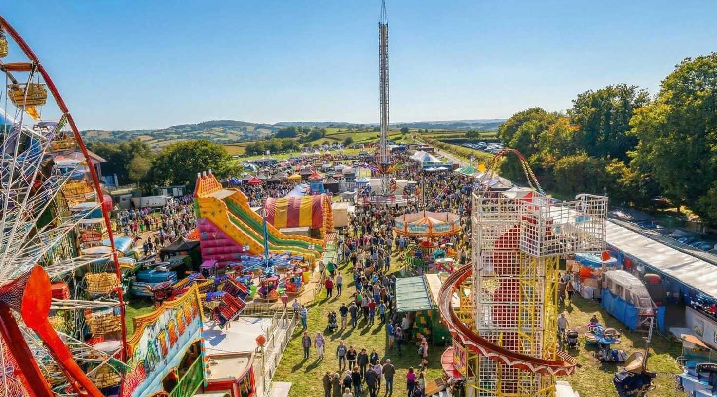Buckham Fair Dorset event crowd and fairground attractions